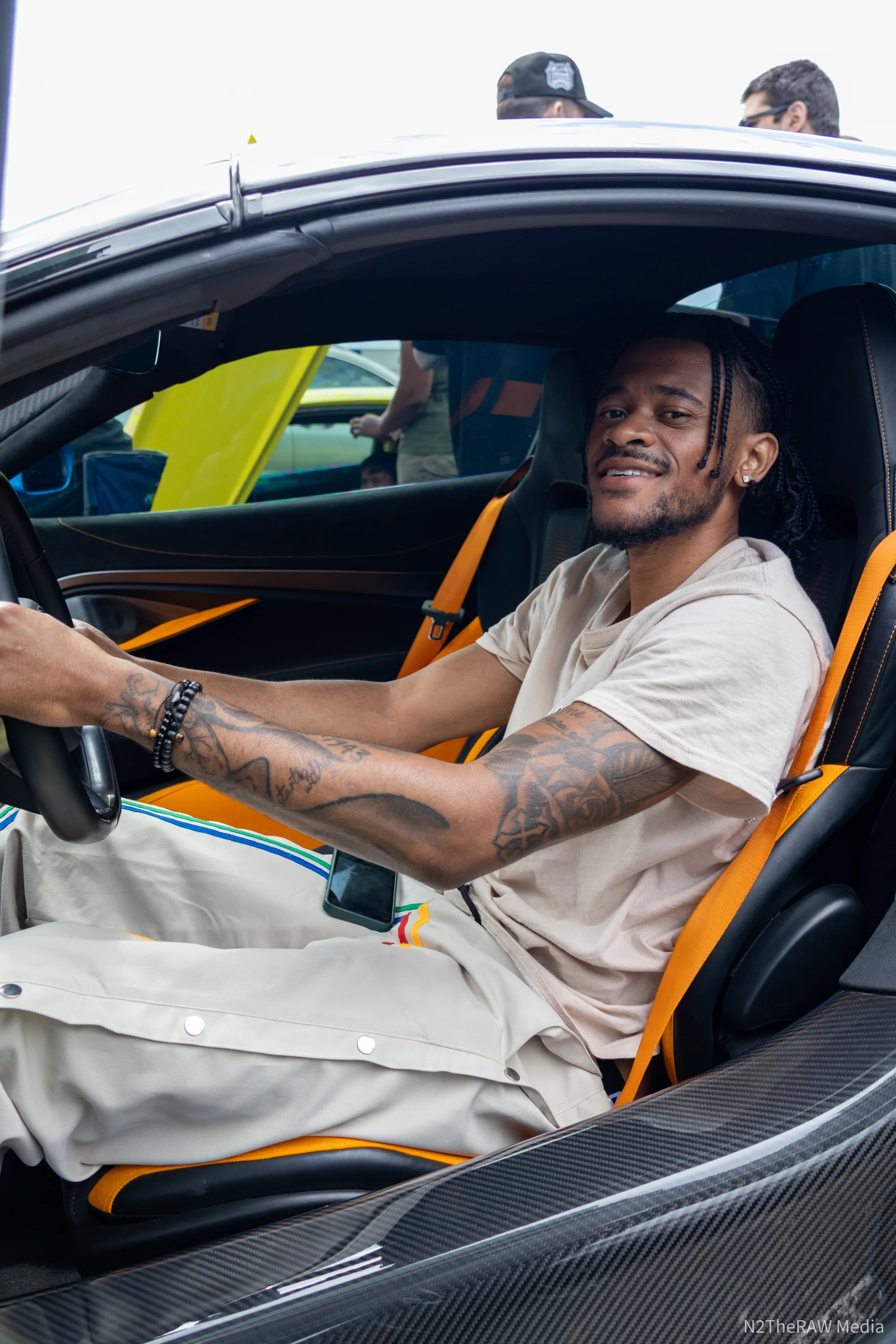 Driver smiling in a McLaren cockpit